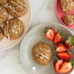 Banana scones on plates with strawberries on side.