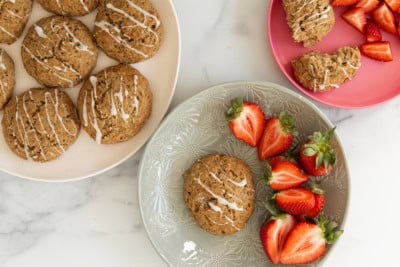 Banana scones on plates with strawberries on side.