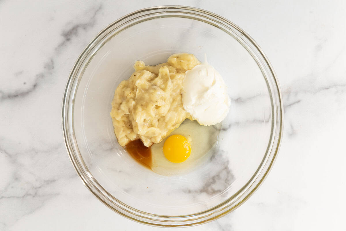 Banana scones ingredients in glass bowl.