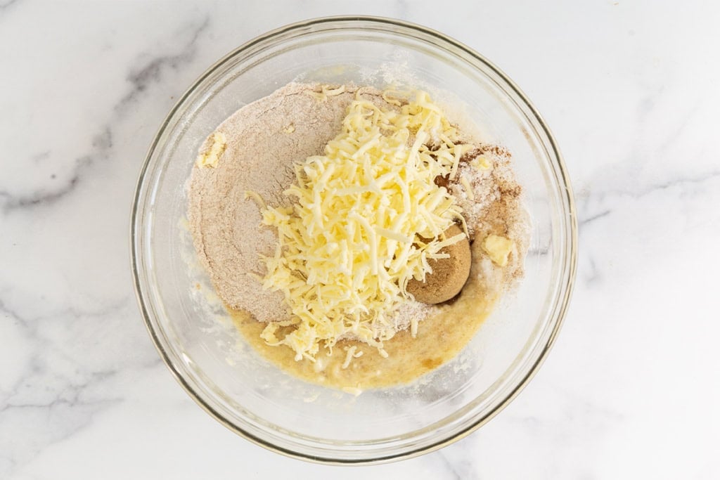 Banana scones ingredients in glass bowl.