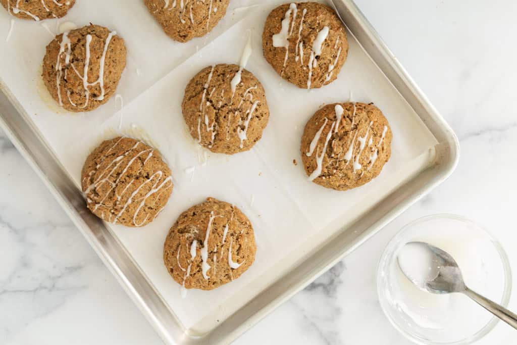 Frosting being drizzled over banana scones.