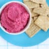 beet-hummus-with-crackers-on-blue-plate