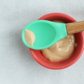 peanut butter puree in small bowl with baby spoon