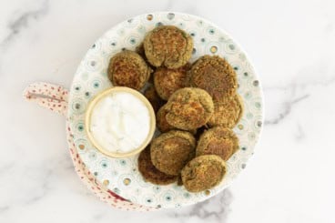 Lentil falafel on plate with dip.