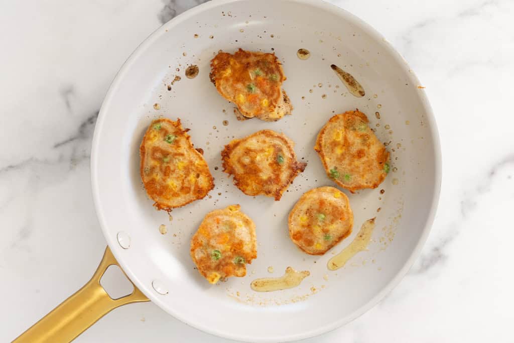 Vegetable pancakes in frying pan.