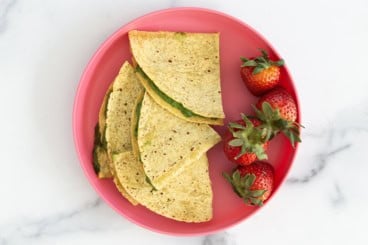 spinach quesadillas on pink plate.