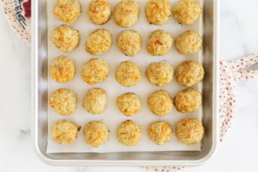 baked chicken meatballs on cookie sheet.