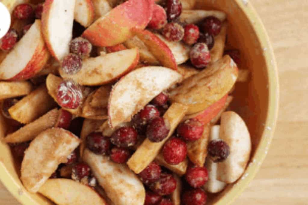 Cranberry apple pie filling in yellow bowl.