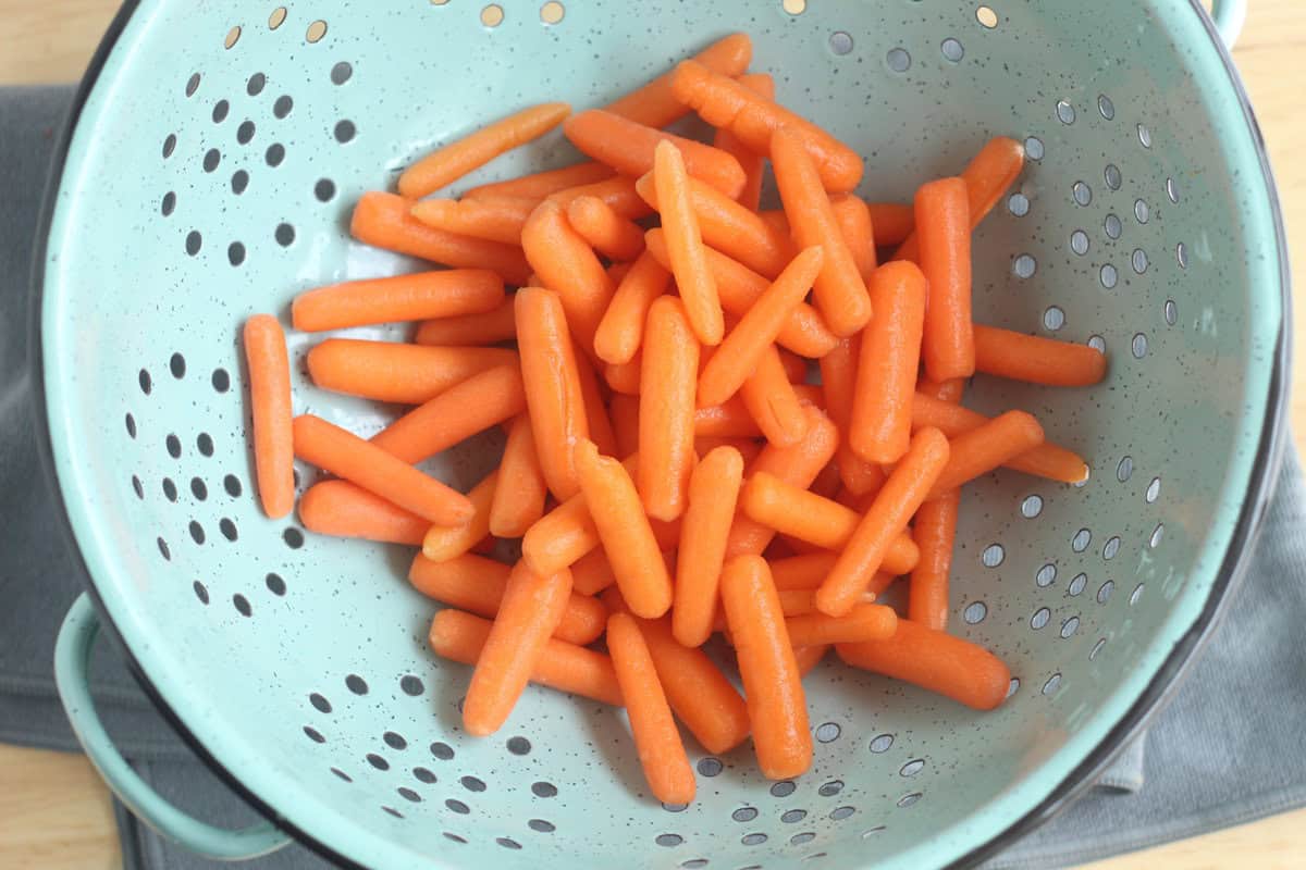 Baby carrots in strainer. 