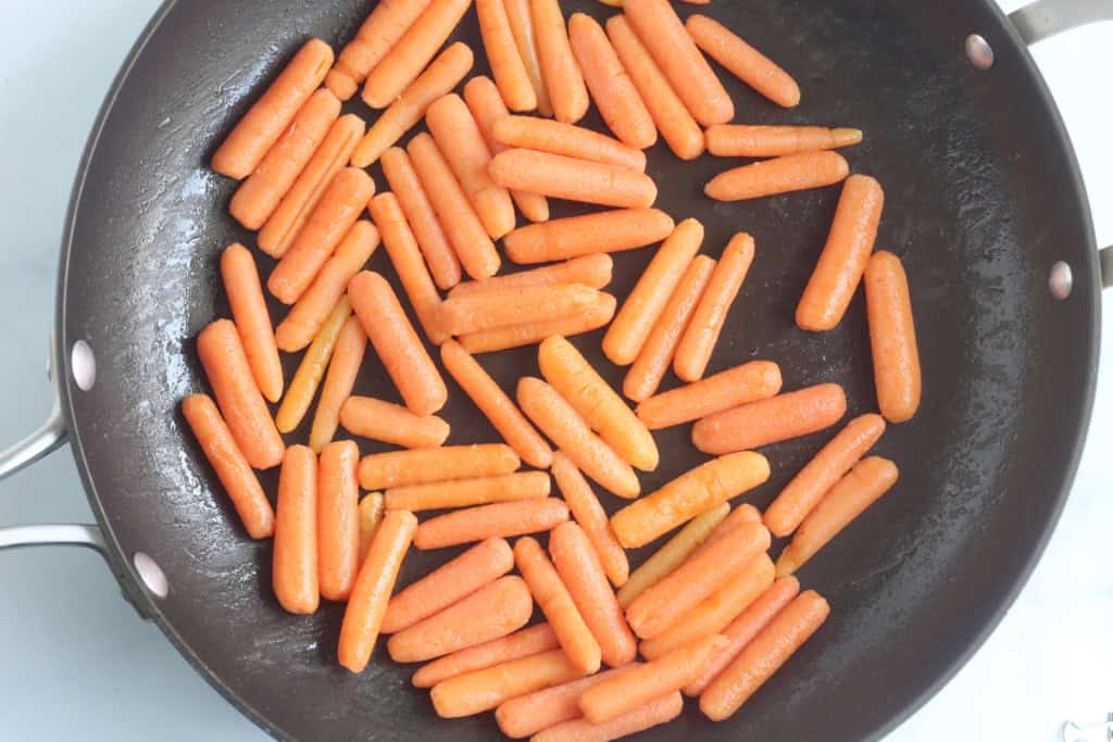 Baby carrots in frying pan.