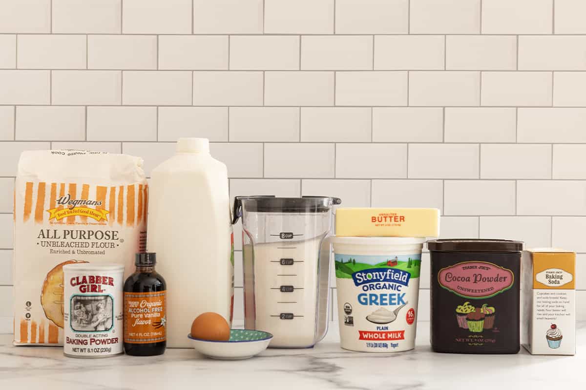 Ingredients for chocolate baked donuts on countertop.