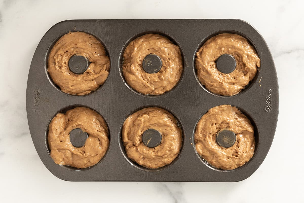 Chocolate baked donuts in donut pan before baking.