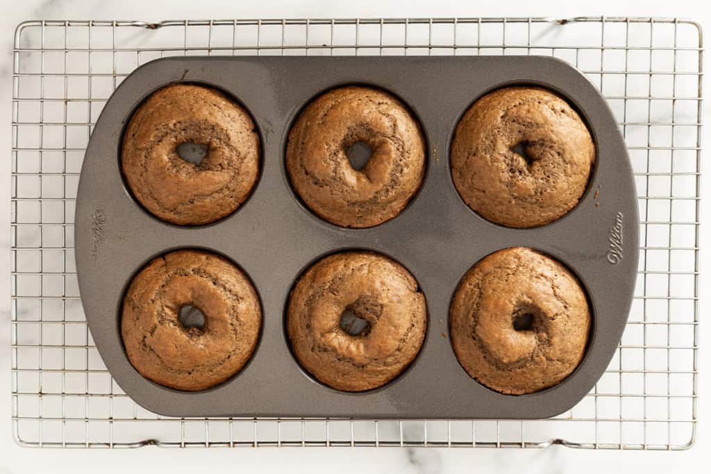 Chocolate baked donuts in donut pan after baking.