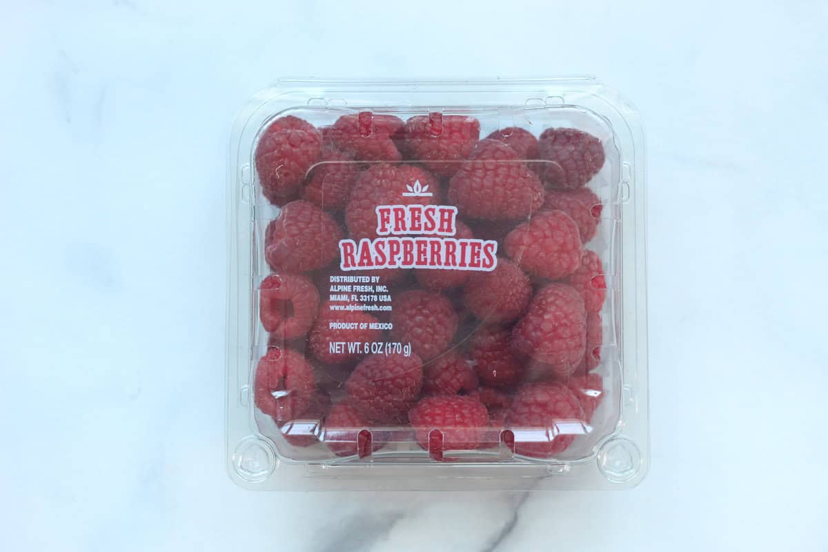 Raspberries in container for raspberry puree. 