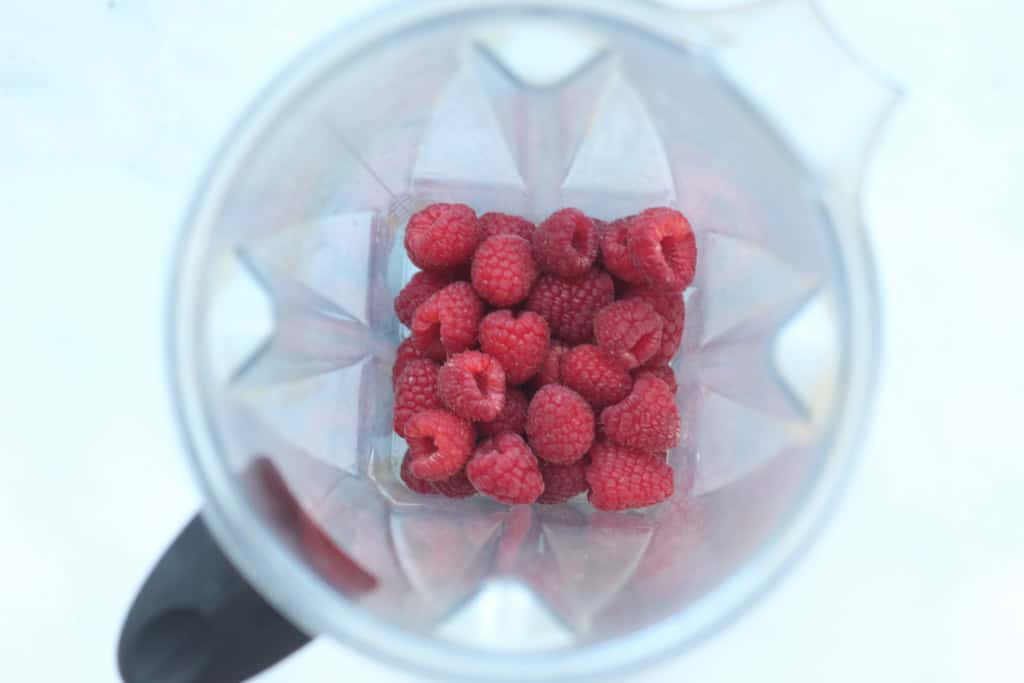 Raspberries in blender for raspberry puree.