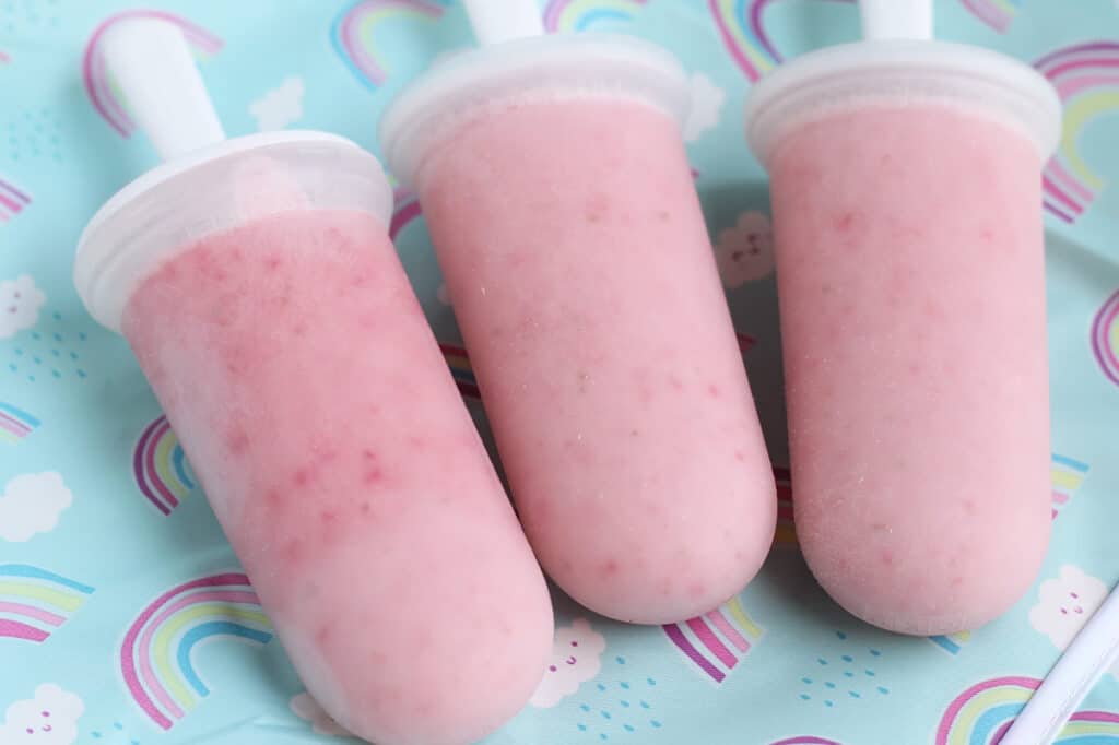 strawberry popsicles in freezer pop molds.