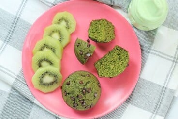 sliced spinach banana muffin on kids plate.