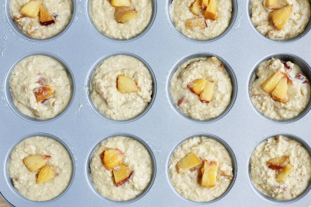 Peach muffins in muffin pan before baking. 