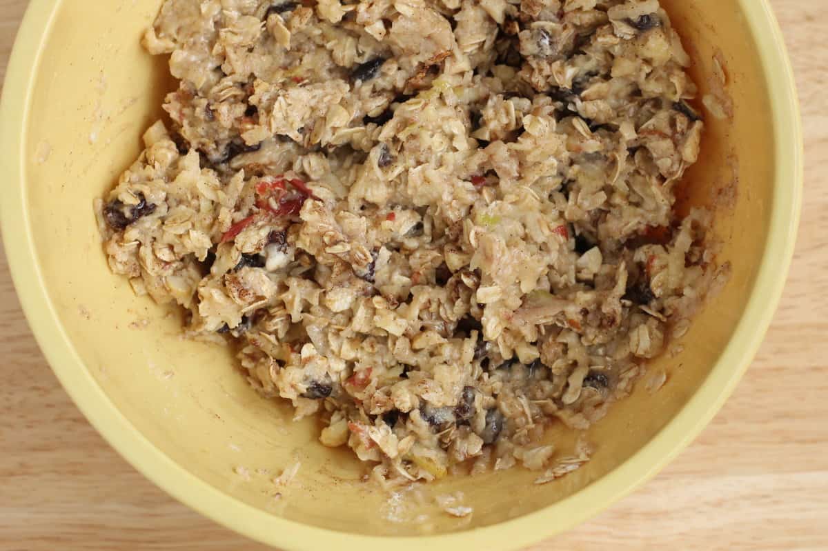 Dough for apple cookies in yellow bowl. 