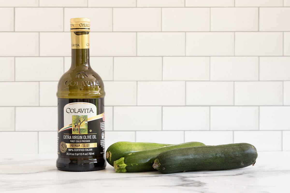 Ingredients for roasted zucchini on countertop.