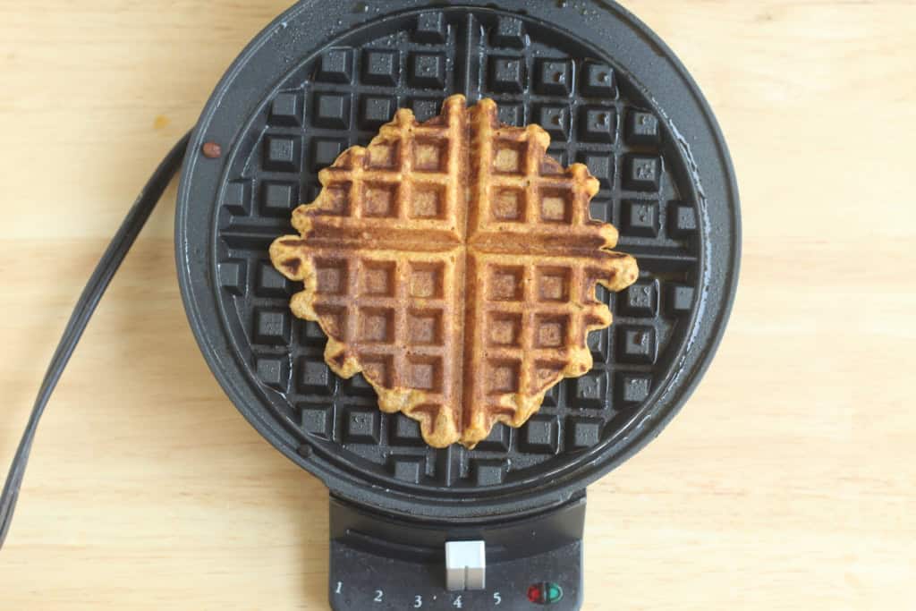 Sweet potato waffle in waffle iron after cooking.