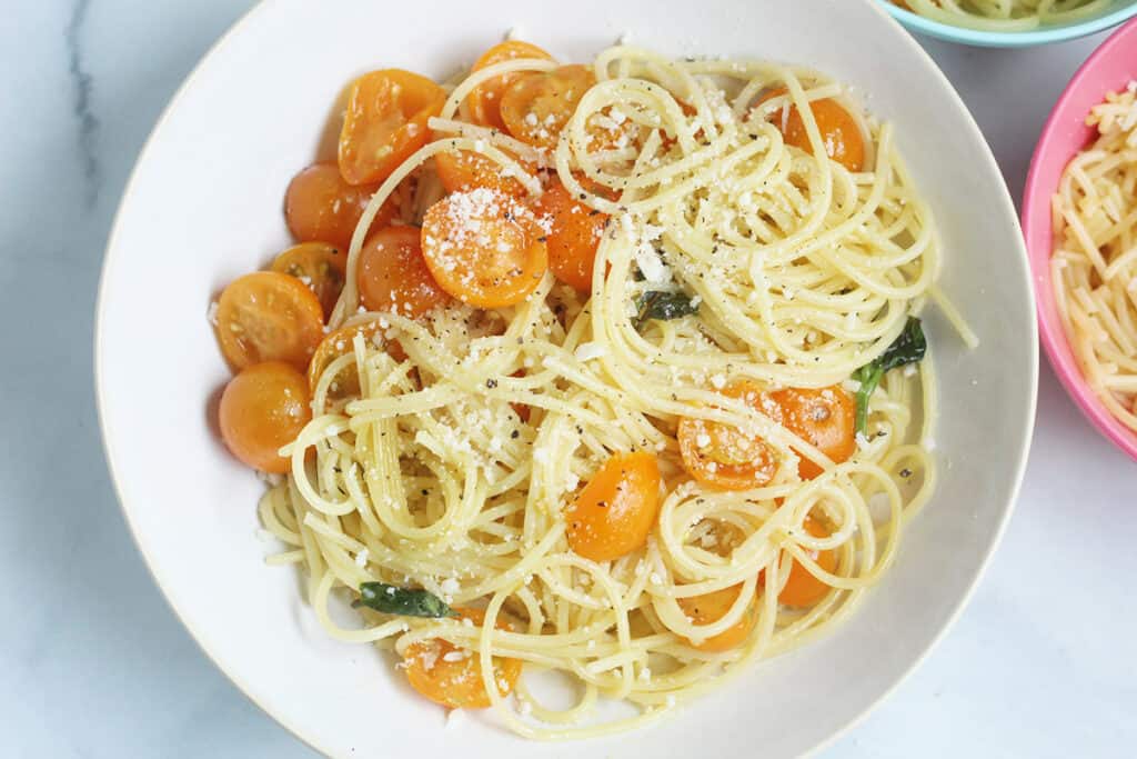 cherry tomato pasta in white bowl
