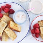 eggnog french toast on two plates with cups.