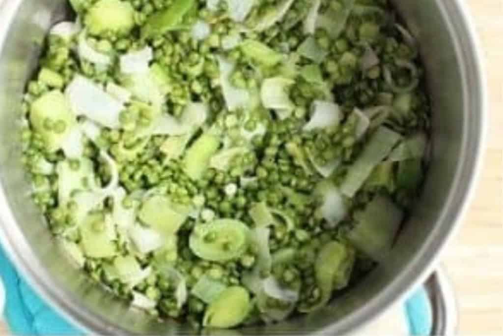 Peas and leaks in pot for broccoli cheddar soup.