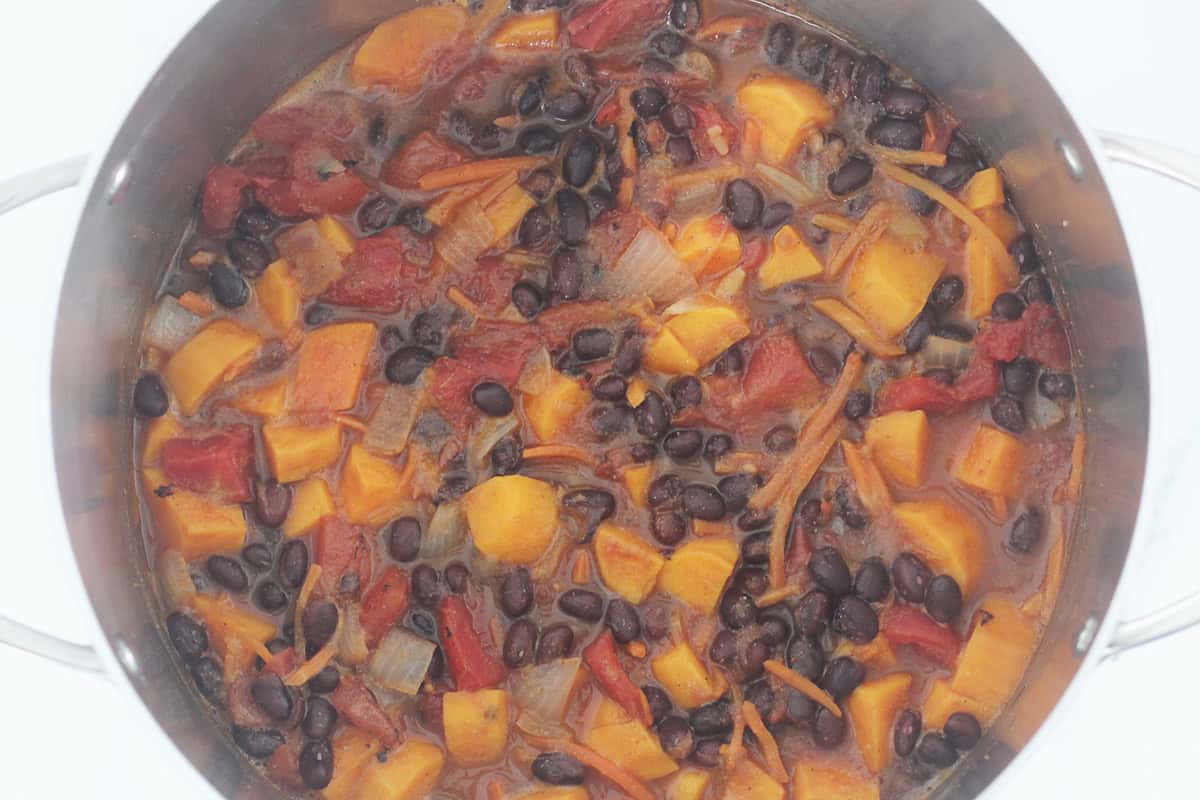 Black bean soup ingredients in pot before pureeing.