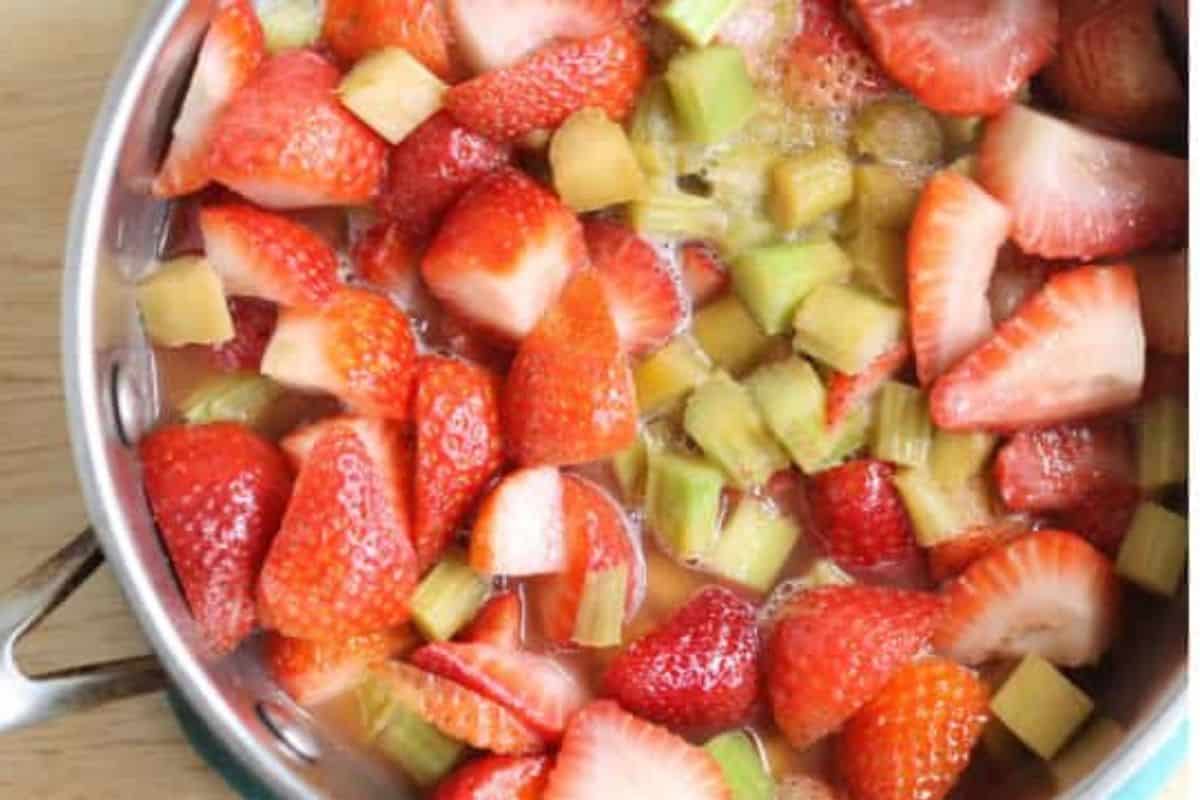 Strawberries and rhubarb in pot for jam. 