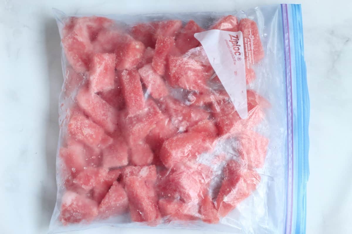 Watermelon cut into pieces frozen in zip top bag.