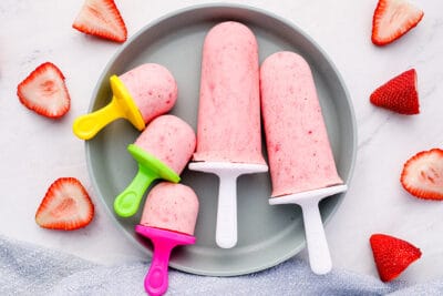 https://www.yummytoddlerfood.com/wp-content/uploads/2022/05/Strawberry-Greek-Yogurt-Pops-on-gray-plate-with-berries-400x267.jpg
