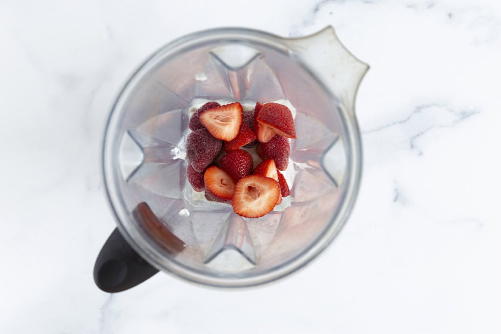 Strawberries in blender for strawberry smoothie.