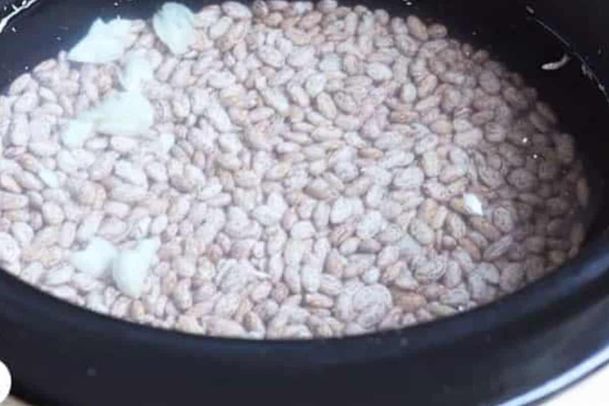 Beans in crockpot before cooking for refried beans. 