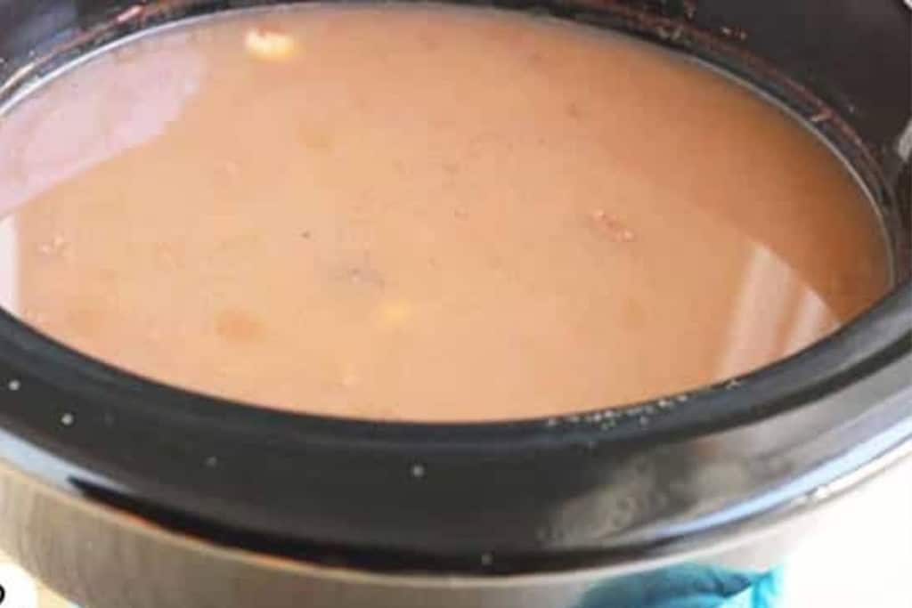 Beans and liquid in crock pot for refried beans.