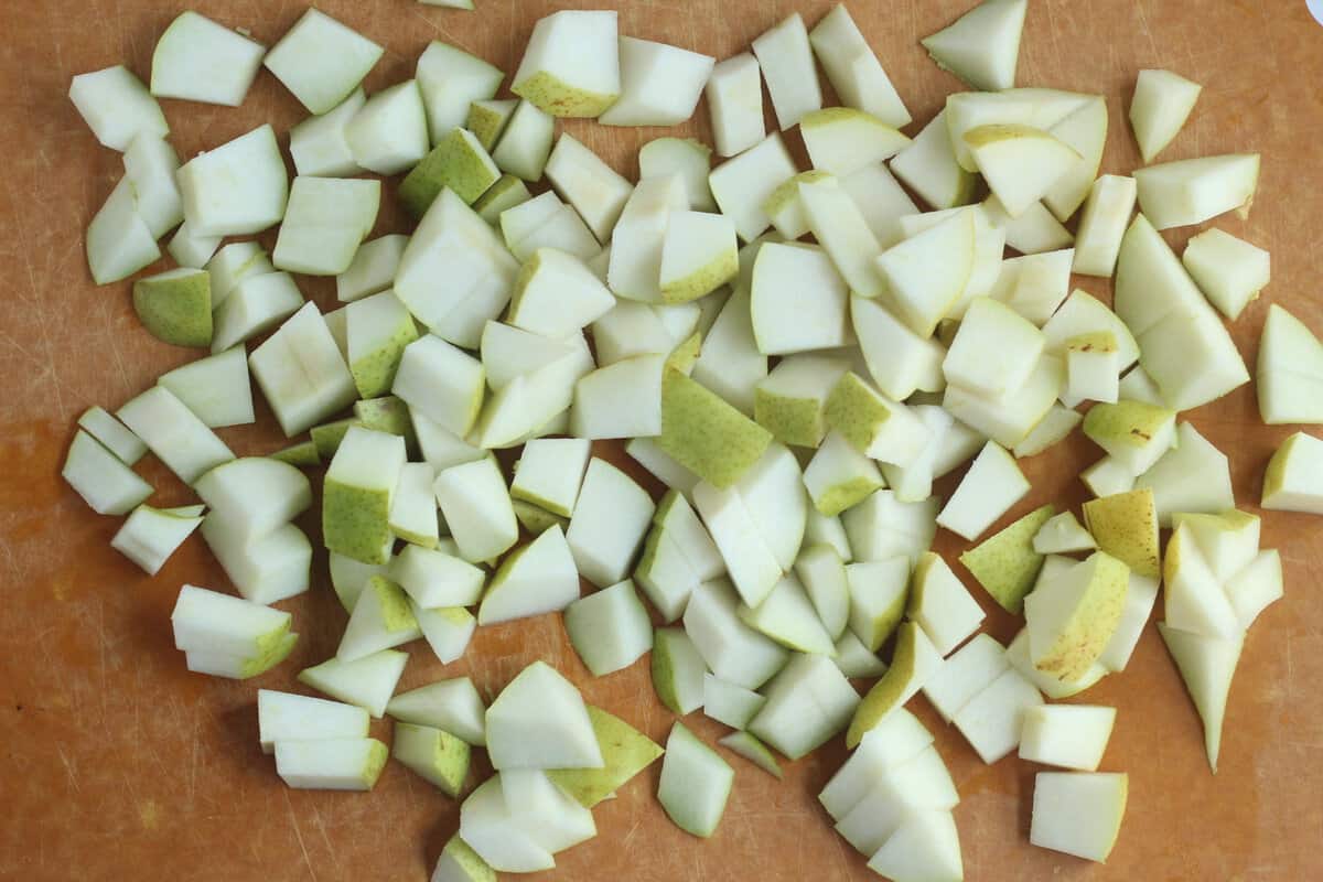 Diced pears on cutting board for pear sauce. 