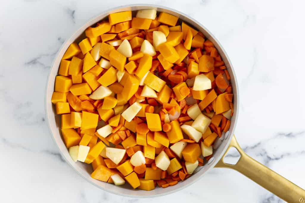 Veggies in pot before cooking for butternut squash soup.