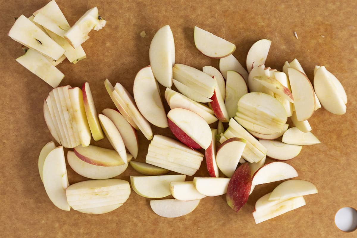 Apple slices on cutting board for cinnamon apples. 