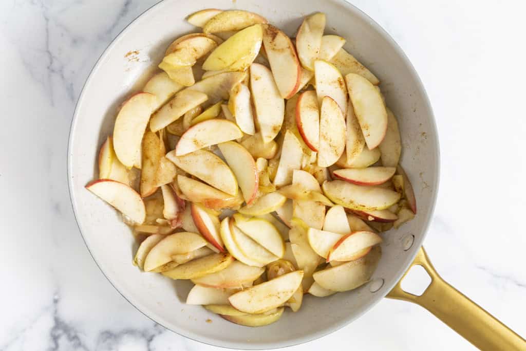 Cinnamon apples in frying pan.