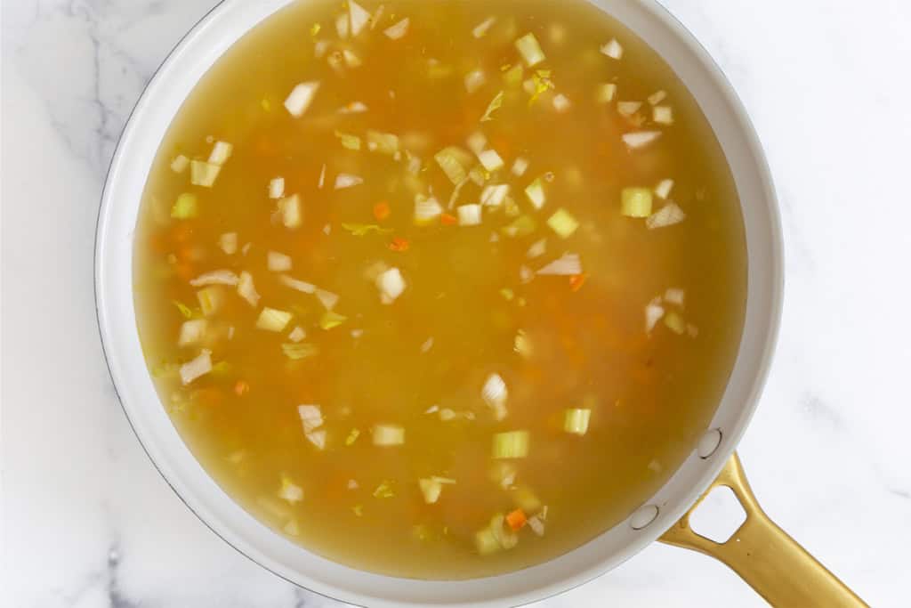 Mirepox and broth in pan for pastina soup.