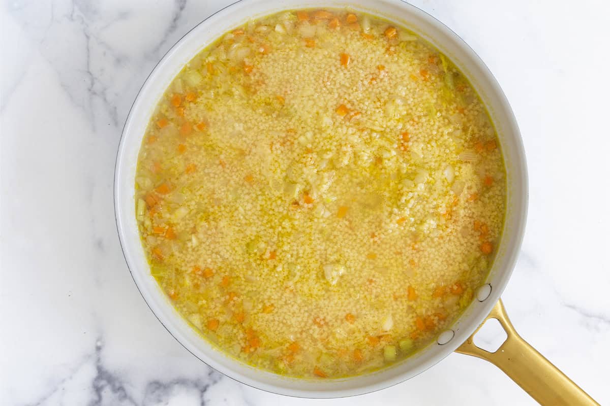 Pastina soup being cooked in pan.