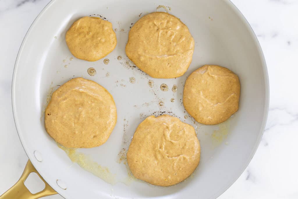 pumpkin pancake batter in pan on stove.