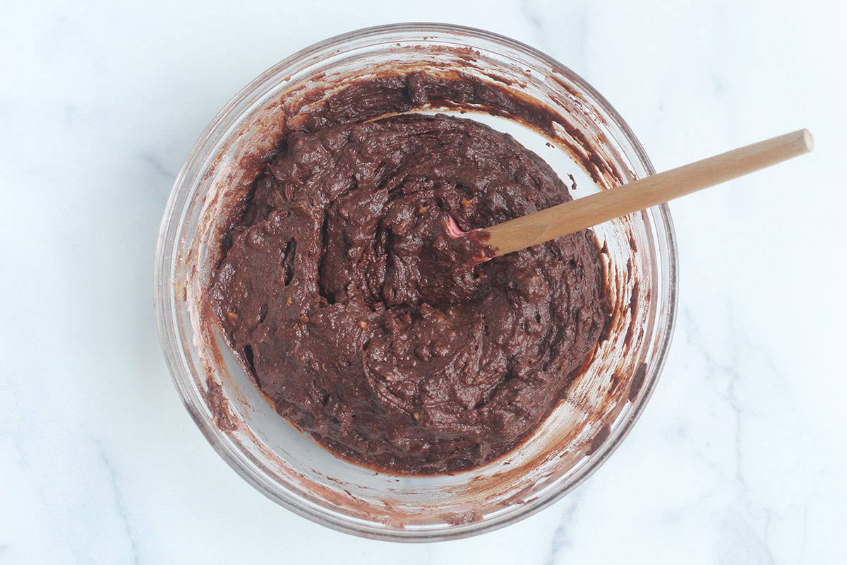 Sweet potato brownie batter in glass bowl.