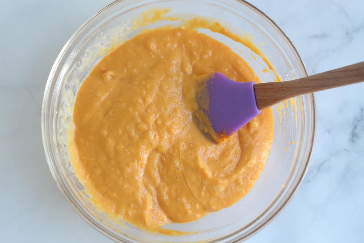 Wet ingredients for sweet potato muffins in glass bowl. 