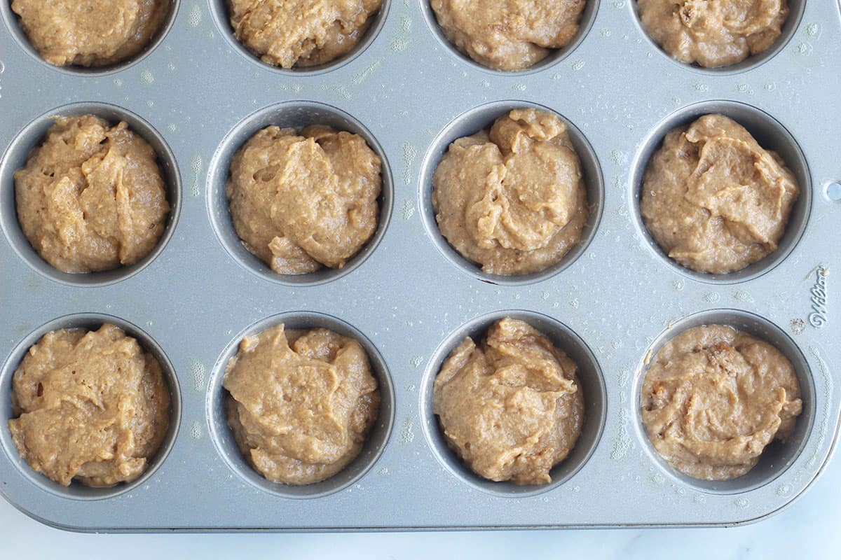 Sweet potato muffins in muffin pan before baking.