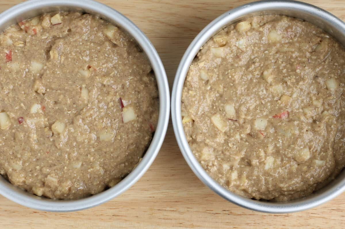 Apple cake in two pans before baking.