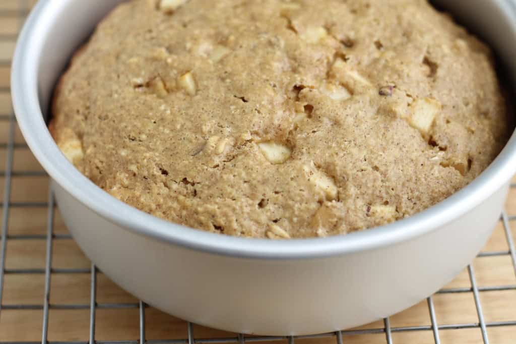 Baked apple cake on cooling rack.