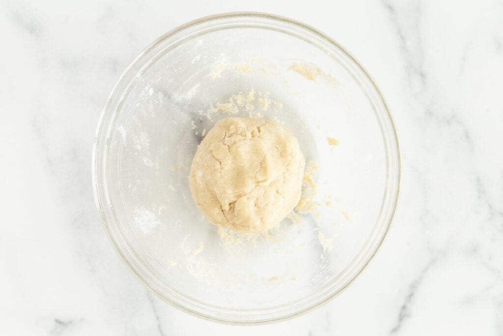 dough for jam cookies in clear bowl on counter.