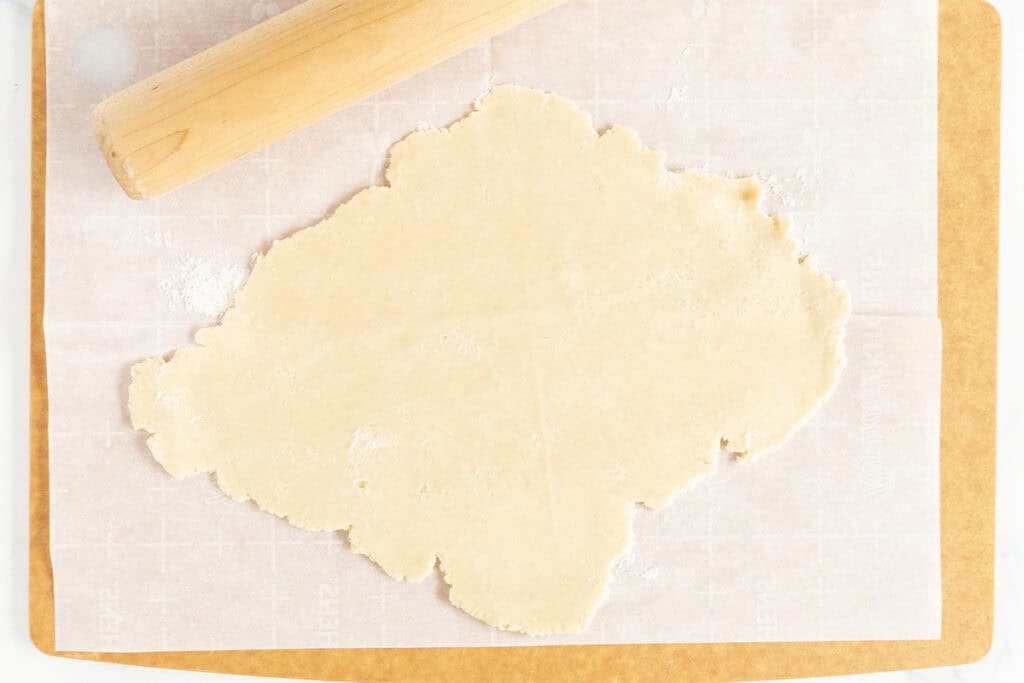 rolled out jam cookie dough on parchment paper.