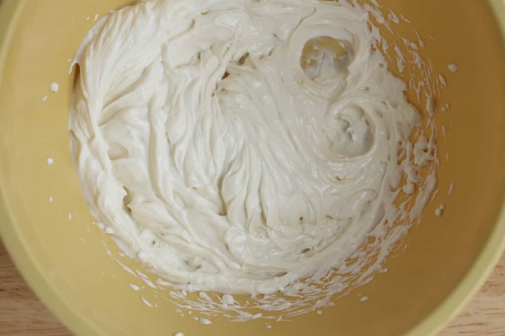 Yogurt frosting in yellow bowl.